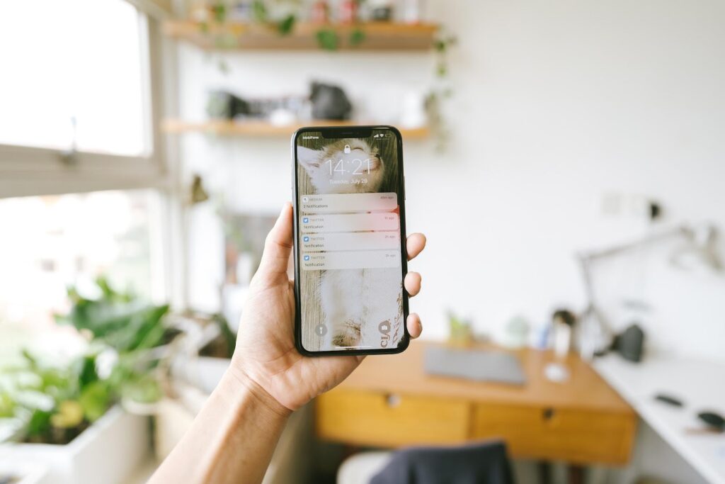Mobile phone in hand with notifications from social media